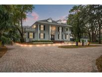 Stunning two-story home featuring a brick driveway, large columns, second floor balcony and a well-manicured front yard at 17062 Comunidad De Avila, Lutz, FL 33548