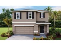 Charming two-story home featuring a symmetrical facade, neutral color palette, and well-maintained landscaping at 36130 Sunflower Hill Dr, Zephyrhills, FL 33541
