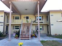 Charming two-story condo with covered entryway, adorned with flowers and outdoor seating at 4518 Narraganset Trl # 85A, Sarasota, FL 34233