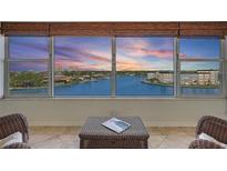 Breathtaking water view from the condo with a picturesque sunset and comfortable seating area at 6075 Shore S Blvd # 509, Gulfport, FL 33707
