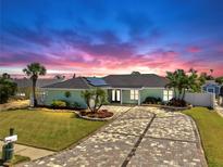 Beautiful single-story home with lush landscaping and a patterned brick driveway at 6511 Senegal Palm Way, Apollo Beach, FL 33572