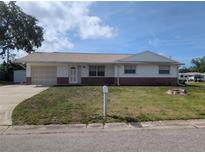 Charming single-story home features an attached garage, neutral paint, and well-maintained front yard at 10968 105Th Ave, Largo, FL 33778