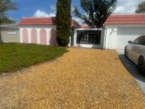 Charming single story home with a gravel driveway and barrel tile roof at 5137 Manor Dr, New Port Richey, FL 34652