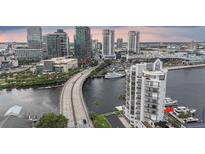Stunning aerial view of waterfront condos with private docks and cityscape backdrop at 600 Garrison Cove Ln # 2B, Tampa, FL 33602