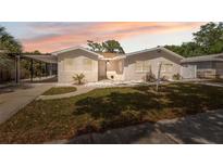 Charming single-story home with a carport, stucco exterior, and well-maintained front yard at 7313 8Th N Ave, St Petersburg, FL 33710