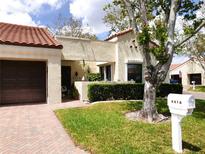 Charming single-story home featuring a red tile roof, attached garage, and mature landscaping at 8810 41St N St, Pinellas Park, FL 33782