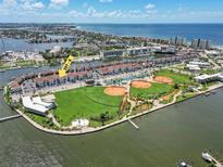 Aerial view of waterfront condos, ROC Park, baseball fields, and beach in Madeira Beach, Florida at 337 Rex Pl # E, Madeira Beach, FL 33708