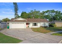 Charming single-story home with a well-maintained lawn, neutral paint, and an attached two-car garage at 10812 96Th St, Largo, FL 33773