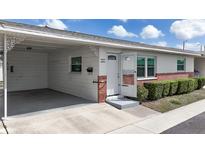 Charming single-story home featuring an open carport and a neatly landscaped front yard at 12400 Park Blvd # 121, Seminole, FL 33772