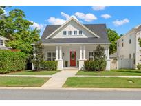 Charming white home featuring a welcoming red front door and a beautifully landscaped front yard at 1511 47Th N Ave, St Petersburg, FL 33703