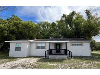 Charming single-story home featuring a covered front porch and inviting curb appeal at 1602 E New Orleans Ave, Tampa, FL 33610