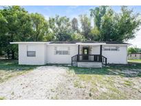 Charming single-story home featuring a covered front porch and gravel landscaping at 1602 E New Orleans Ave, Tampa, FL 33610