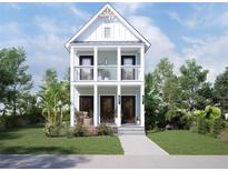 Charming two-story home featuring double balconies, black doors, and professional landscaping at 2308 N 13Th St, Tampa, FL 33605