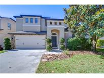 Charming two-story home with a two-car garage, manicured lawn and beautiful landscaping at 2515 Cross More St, Valrico, FL 33594