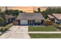 Charming home with a well-manicured lawn, welcoming front porch, and an attached single car garage at 3106 Whispering S Dr, Largo, FL 33771
