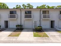 Charming townhouse featuring balconies, garage doors, and a well-maintained exterior at 6462 92Nd N Pl # 804, Pinellas Park, FL 33782