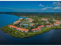 Beautiful aerial view of waterfront condos with community pool, tennis courts and lush landscaping at 1805 Mariner Dr # 52, Tarpon Springs, FL 34689