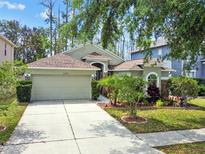 Charming single Gathering home featuring a 2 car garage and beautiful landscaping at 21840 Waverly Shores Ln, Land O Lakes, FL 34637