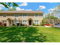 Inviting townhome with a well-manicured lawn and charming architectural details on a sunny day at 2897 Thaxton Dr # 62, Palm Harbor, FL 34684