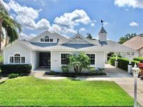 Charming single-story home with a manicured lawn and beautiful landscaping at 4604 Blue Marlin Dr, Bradenton, FL 34208