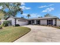 Charming single-story home features a well-maintained lawn, spacious driveway, and a two-car garage at 4704 Travertine Dr, Tampa, FL 33615