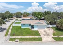 Charming single Gathering home featuring a well maintained lawn and an attached two car garage at 6035 19Th Ne St, St Petersburg, FL 33703