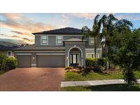 Beautiful two-story home with a three-car garage, brick driveway, and well-maintained landscaping at 10712 Pleasant Knoll Dr, Tampa, FL 33647