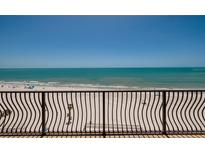 Beautiful beach view from balcony with railings on a clear day at 13600 Gulf Blvd # 700A, St Petersburg, FL 33708