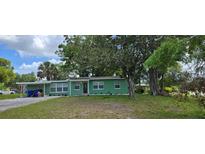 Charming single-story home featuring a well-maintained lawn and mature trees at 1615 Stevensons Dr, Clearwater, FL 33755