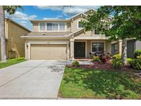 Charming two-story home with a well-maintained lawn and attached two car garage at 2800 Flagler Ct, Trinity, FL 34655