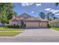 Charming single-story home featuring a three-car garage, well-maintained lawn, and welcoming curb appeal at 2927 Hickory Grove Dr, Valrico, FL 33596
