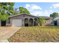 Charming single-story home featuring a well-kept lawn, arched entryway, and a one-car garage at 3961 15Th N Ave, St Petersburg, FL 33713