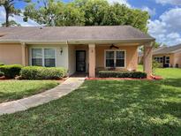 Charming single-story home with well-maintained landscaping, a covered entryway, and a welcoming front lawn at 4814 Grist Mill Cir, New Port Richey, FL 34655