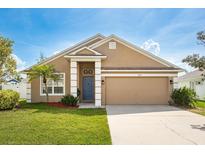 Charming single-story home with a well-manicured lawn, tidy landscaping, and a two-car garage at 632 Lake Cypress Cir, Oldsmar, FL 34677