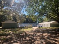 Spacious property featuring multiple storage units and mature trees at 832 S Parsons Ave, Brandon, FL 33511