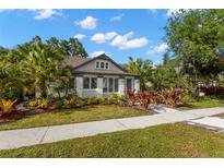 Charming single-story home with lush landscaping, mature trees, and inviting curb appeal at 115 21St Ne Ave, St Petersburg, FL 33704
