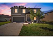 Beautiful two-story home featuring manicured lawn and a two-car garage, perfect for a growing Gathering at 1547 Golden Glow Dr, Ruskin, FL 33570