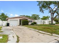 Charming single-story home featuring a well-maintained lawn and an attached one-car garage at 1759 Massachusetts Ne Ave, St Petersburg, FL 33703
