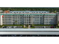 Multi-story condominium complex featuring lush landscaping and covered parking at 2960 59Th S St # 615, Gulfport, FL 33707