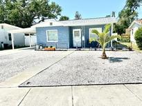 Charming single-story home with blue siding, a well-manicured yard, and a young palm tree at 3318 Boca Ciega N Dr, St Petersburg, FL 33710