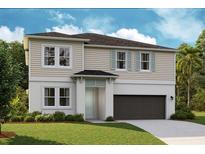 Charming two-story home featuring a neutral color palette, attached two car garage, and well maintained lawn at 12168 Cattleside Dr, Riverview, FL 33579