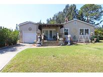 Charming single Gathering home with a spacious, well-maintained lawn and beautiful front porch at 2132 40Th N Ave, St Petersburg, FL 33714