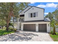 Stunning modern farmhouse with a three-car garage and inviting balcony at 3406 W Alline Ave, Tampa, FL 33611