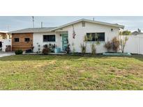 Charming single-story home featuring a well-kept front yard, decorative landscaping and blue trim at 428 45Th N Ave, St Petersburg, FL 33703