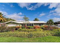 Well-maintained single-story home with lush landscaping and charming curb appeal at 502 Palm Dr, Largo, FL 33770