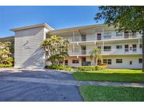 Well-maintained building featuring a classic design, mature trees, and neatly manicured landscaping at 5155 9Th N Ave # 102, St Petersburg, FL 33710