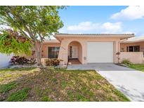 Charming single-story home featuring a well-maintained lawn and attached garage at 5428 Larchmont N Ct # 5428, Pinellas Park, FL 33782