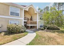 Inviting condo exterior featuring a private entrance, mature landscaping, and a well-maintained facade at 9481 Highland Oak Dr # 1616, Tampa, FL 33647