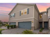 Charming townhome features a two-car garage, neutral colors and decorative shutters at 11638 Woodleaf Dr, Bradenton, FL 34211