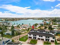 Stunning aerial view of property near waterfront featuring lush landscaping and community pool at 187 145Th E Ave # 4, St Petersburg, FL 33708